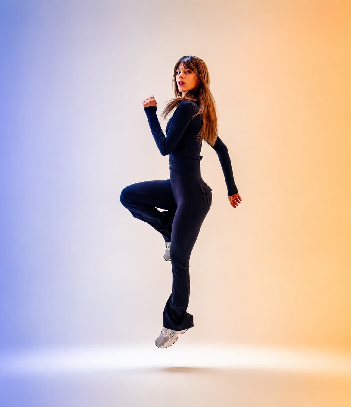 Full-body editorial portrait with gradient lighting photographed at VibeShack Studios