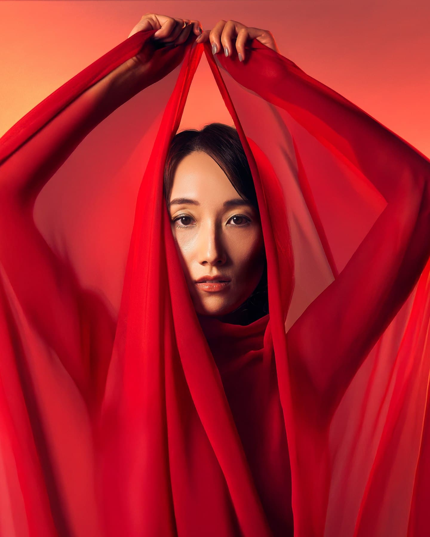 Close editorial portrait with red fabric photographed at VibeShack Studios